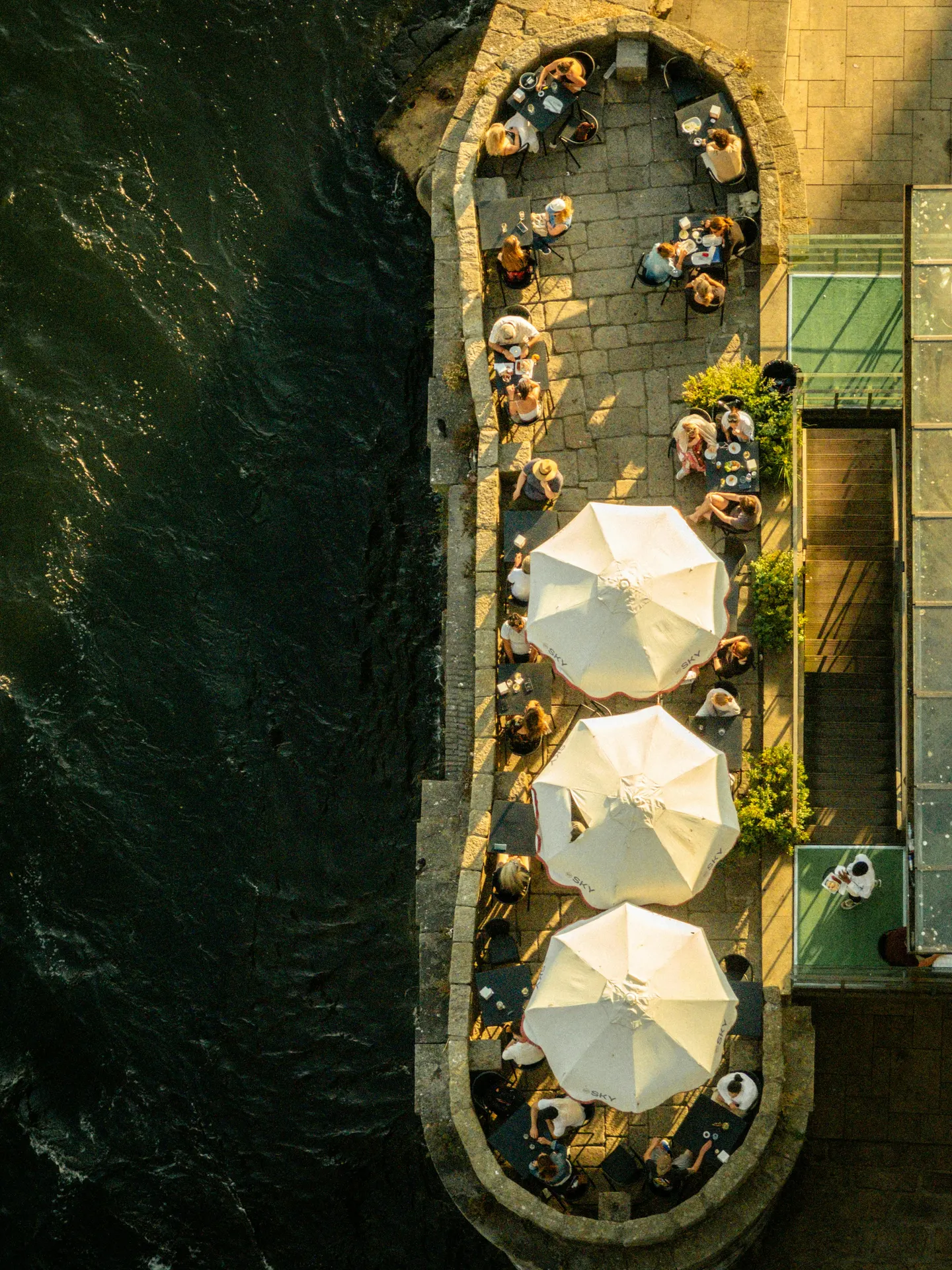Irish riverside café terrace with soft morning reflections